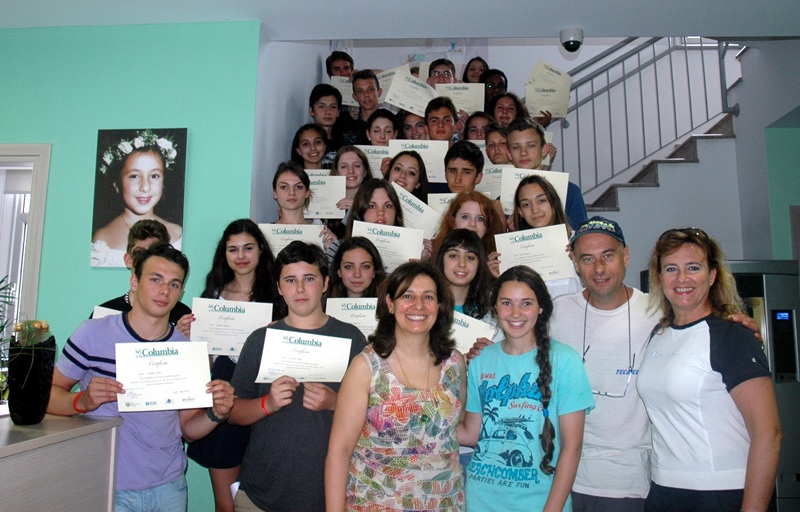 English students holding their certificates